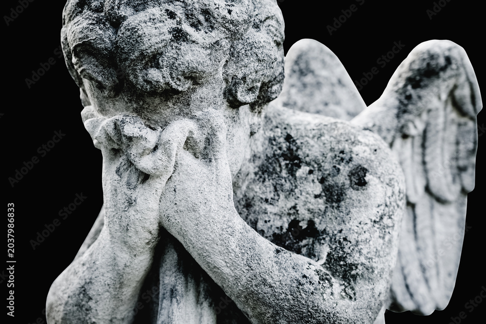 Obraz premium Mourning angel statue grieving for a lost child.