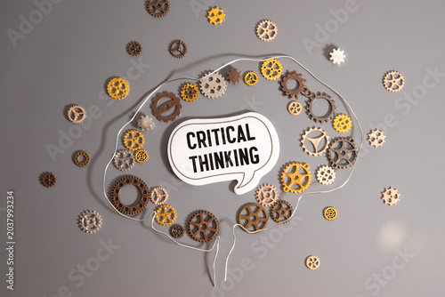 Critical Thinking Concept with Brain Shaped Gear Mechanism and Speech Bubble on Gray Background
