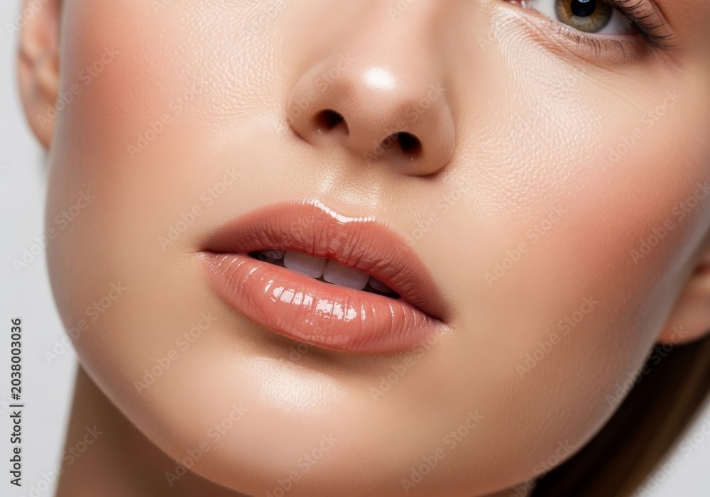 Naklejka premium Close-up shot of radiant hydrated skin and glossy nude lips with a serene expression, captured in high-end editorial fashion photography, sophisticated, glossy, luxury