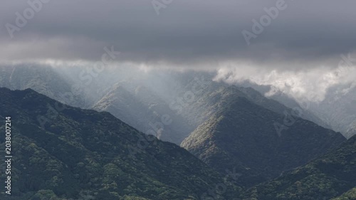 Forest mountain peaks and valleys in dramatic morning light and clouds - Yakushima, Japan