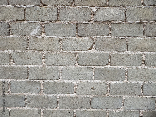 Textured grey concrete block wall with rugged mortar lines creating a durable construction surface