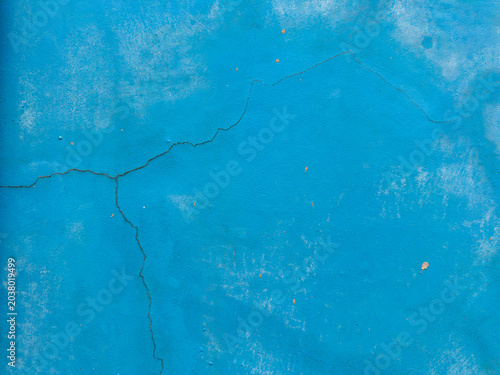 Textured azure panel revealing a tapestry of fine cracks and faded patches showcasing a rich