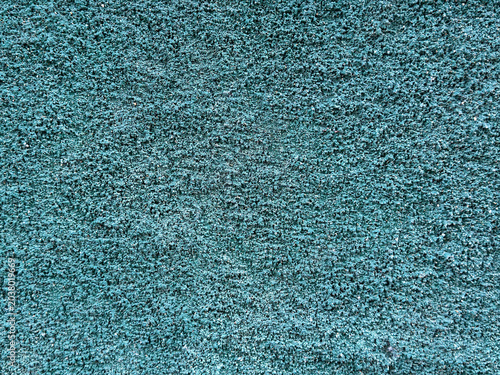 Vibrant teal granular surface showcasing a rugged yet consistent texture ideal for modern backdrops