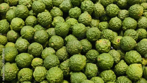 Schilderij op canvas An overhead full-frame shot captures a dense collection of bumpy-skinned kaffir limes, showing their distinct wrinkled texture at a fresh produce stall