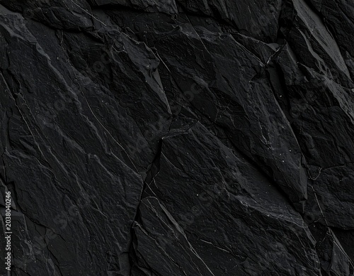 Dark, textured, slate-like rock face