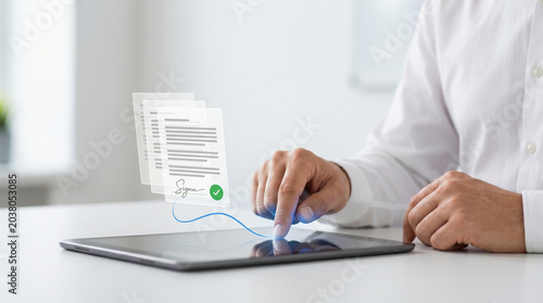 Businessman finger tapping tablet screen to approve electronic contract with glowing digital signature paper documents and green checkmark icon for legal verification concept