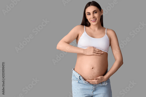 Young pregnant woman on lig...