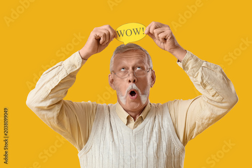 Shocked senior man holding ...