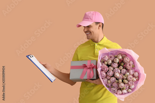 Male courier with bouquet o...