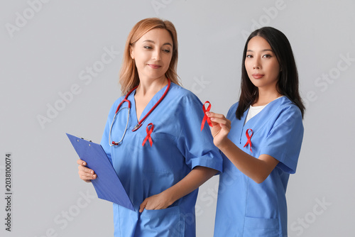 Female doctors with red rib...