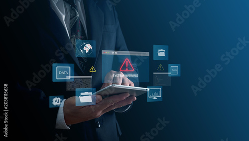 Concept of cybersecurity risk detection, data error interface, IT failure dashboard shown through. Business professional touching glowing digital warning icon virtual screen environment.