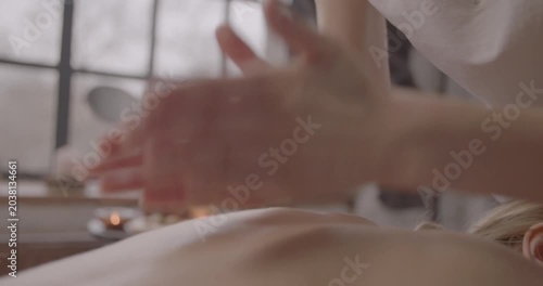 Professional woman receiving relaxing back massage in spa salon