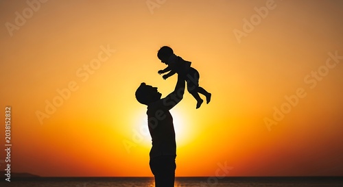 Silhouetted Father Lifting Baby Against Sunset