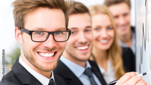 Confident business team standing in a row during an office meeting presentation with business