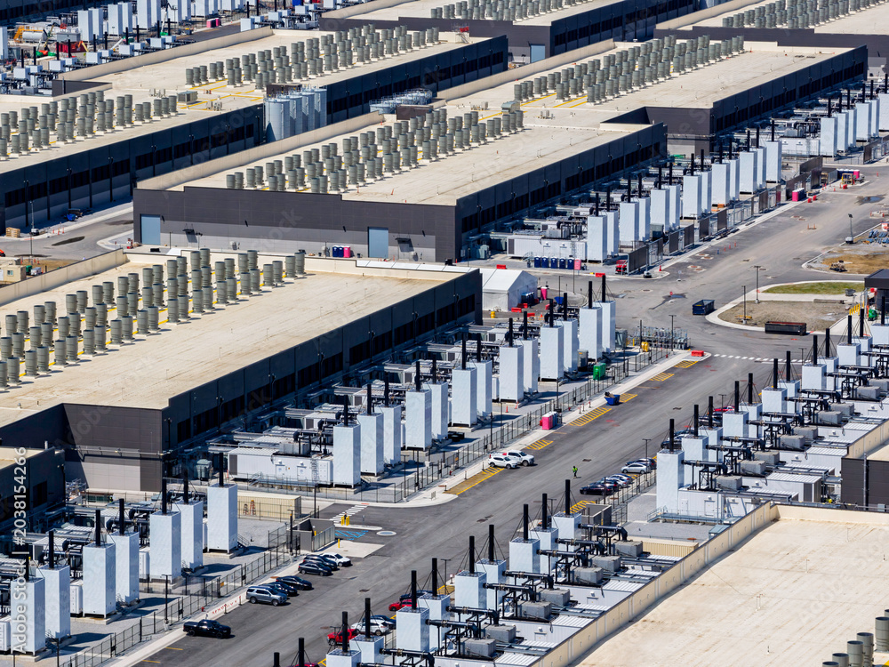 Obraz premium Aerial view of the data center buildings, large AI center structure surrounded by cooling and power systems
