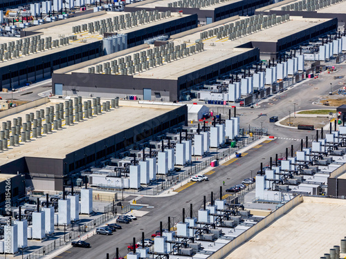 Aerial view of the data center buildings, large AI center structure surrounded by cooling and power systems