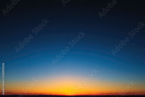 Evening sky gradient from dark blue to fiery orange