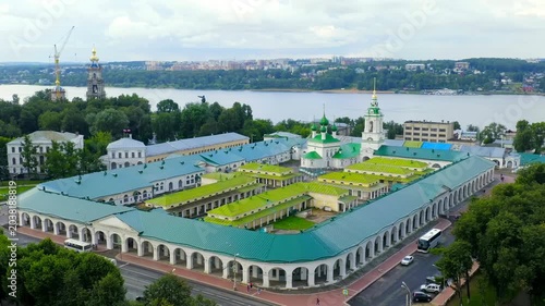 Kostroma, Russia. Church of the Savior in the Rows, five green domes and classical bell tower integrated into historic Neoclassical trading arcades, Drone footage over the Volga River. Drone footage