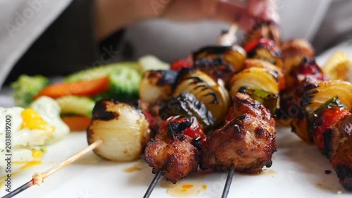 Grilling skewers with meat and vegetables at outdoor cookout