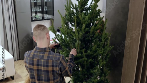 Family decorating festive christmas tree with colorful baubles, sharing joyful moments, bonding in cozy home atmosphere during holiday season