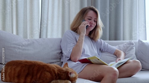 Woman talking on a cell phone while sitting on a couch
