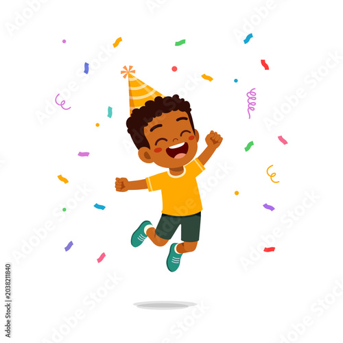 Happy excited darkskinned boy jumping joyful with party hat and colorful confetti celebrating