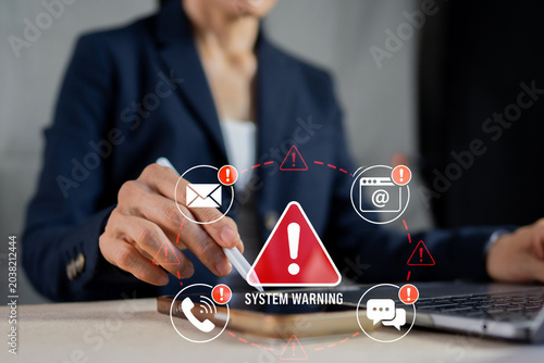 Bild auf Leinwand Businesswoman receiving critical system warning notifications and alerts on tablet in an office
