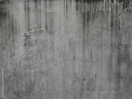 black mold indicating damp on outside white cement wall.