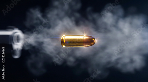 Close-up of a bullet leaving a handgun with smoke and motion effect on dark background. Dramatic action concept representing danger, velocity, power, crime, security and ballistic force.