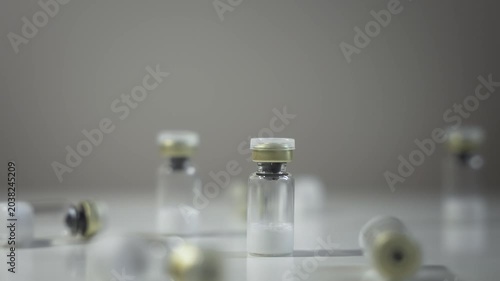 Hand Picks Up Vial and Places Back on Table, Static Shot [Peptide Concept]