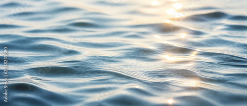 Gentle Waves Reflecting Sunlight on a Serene Water Surface
