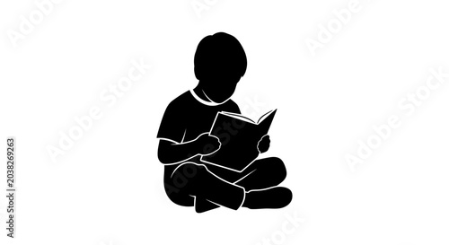 Obraz na plátně Child sitting on the floor while engrossed in reading a book captures the essence of early education, imagination, quiet study, and the joy of learning