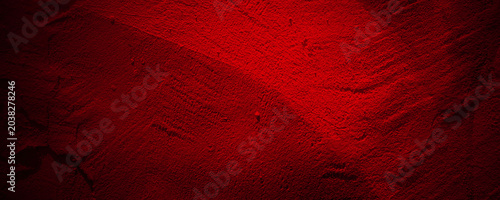 Φωτογραφία Bright crimson textured paint surface with dark shadows and dramatic lighting on a deep maroon colored wall