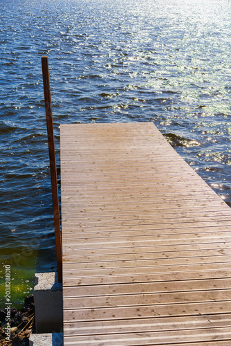 Wooden pier on the lake in sunny summer day, Liepaja, Latvia.