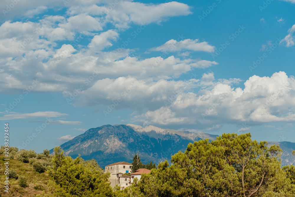 Fototapeta premium Mount Tomorr rising above rural landscape near Berat, Albania