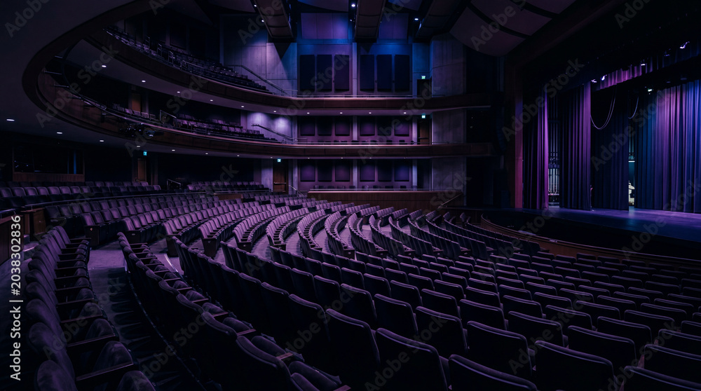 Fototapeta premium Empty Auditorium At Dusk Featuring Purple Blue Ambient Lighting And Cinematic Modern Interior Architectural Serenity Atmosphere