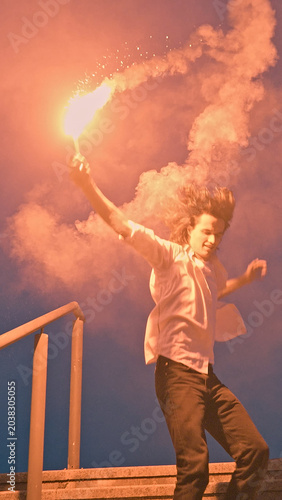 Foto A young skateboarder in adolescence captures a moment of pure exhilaration, holding a flaming torch aloft against a vibrant sunset, symbolizing the carefree spirit and exuberance of youth culture