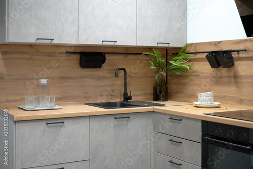 Photos Large modern kitchen with built-in appliances, sink, faucet.