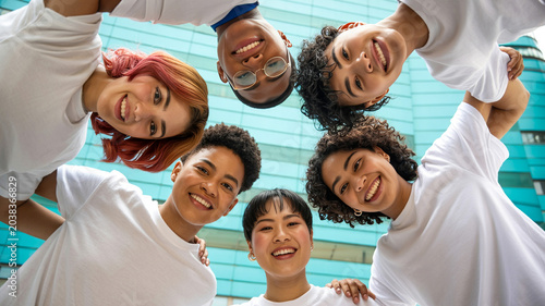 Diverse group of friends laughing together in swimming pool