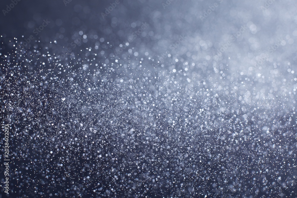 Fototapeta premium Sparkling bokeh effect with shimmering light particles on a dark background.