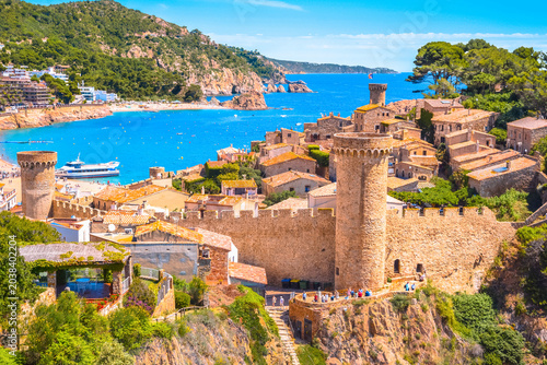 Quadro su tela Vibrant panoramic view of Tossa de Mar medieval old town walls, historic architecture, and blue sea coast, Costa Brava, Spain