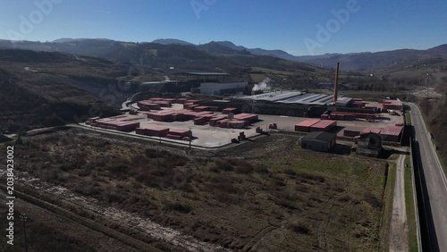 Fotografie Aerial view of a sprawling industrial facility featuring numerous rows of red br