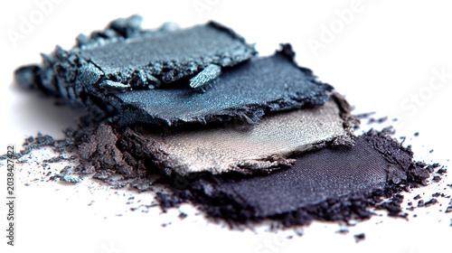 Eyeshadow in dark blue, grey and silver with a shimmering effect, applied to a white surface.