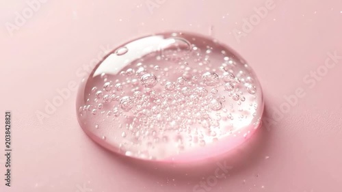Macro Shot of Clear Cosmetic Gel Droplet with Air Bubbles on Pastel Background