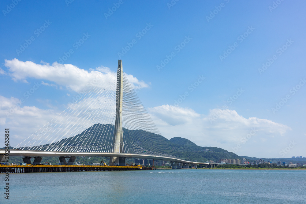 Fototapeta premium Danjiang Bridge in Tamsui Taiwan with blue sky