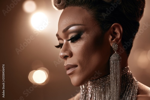 Elegant woman with glamorous makeup and sparkling earrings in soft light