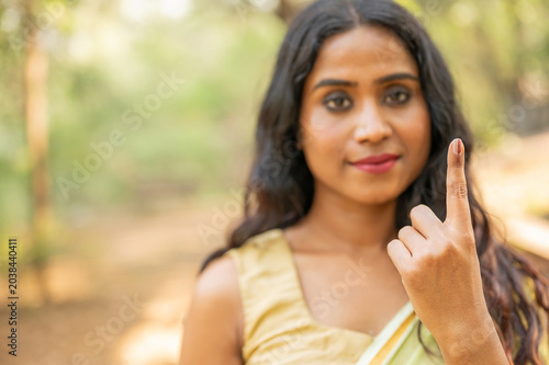 Indian woman showing elections mark on the finger