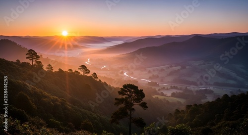 Sunrise over mountains with trees landscape.