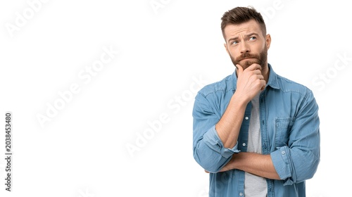 A person standing with hand on chin and a thoughtful look. Isolated on white background.