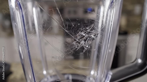 Close up of a cracked blender jar with debris inside.